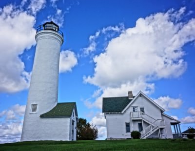 view of a lighthouse and a house next to it