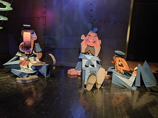 puppet of crew members sitting on the deck