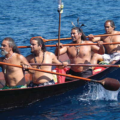 4 men paddling a tomol