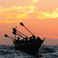 A Tomol being paddled at sunrise