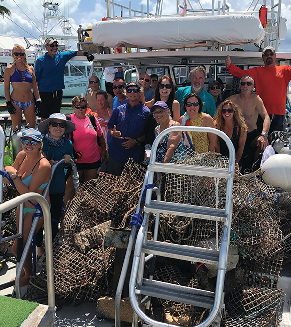 A group celebrates around recovered marine debris