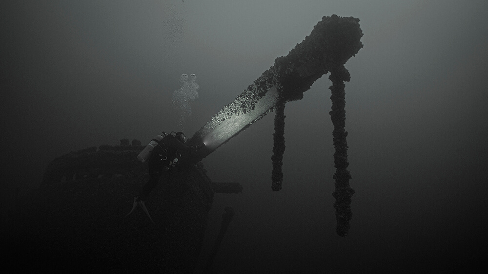 a black and white photo of the bow of a wooden shipwreck