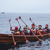 People paddle a tomol