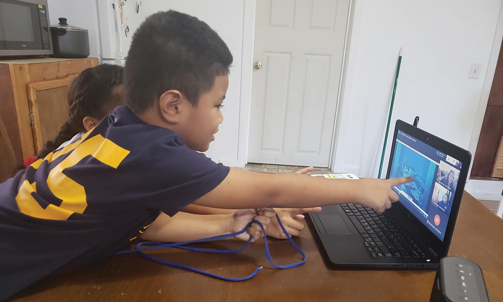 kid pointing at a computer screen