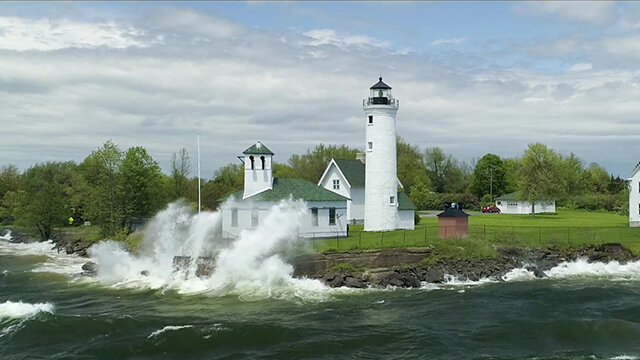 Waves crashing near a lighthouse