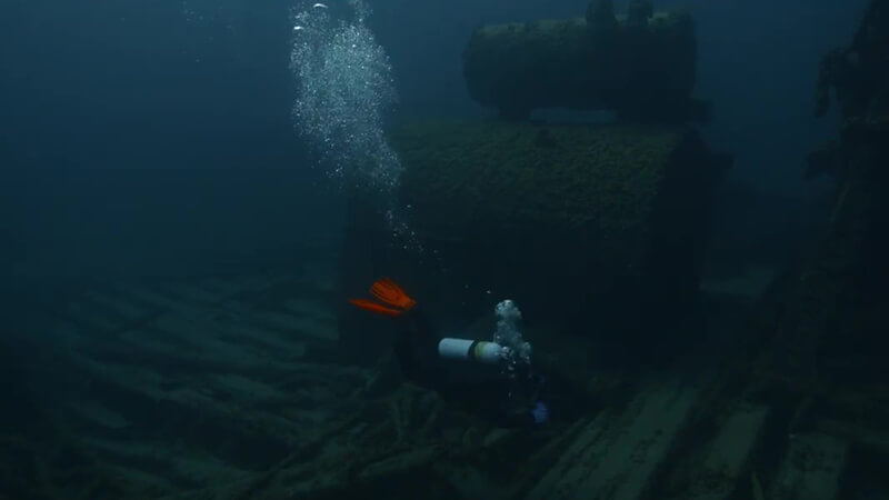 Diver inspects a shipwreck