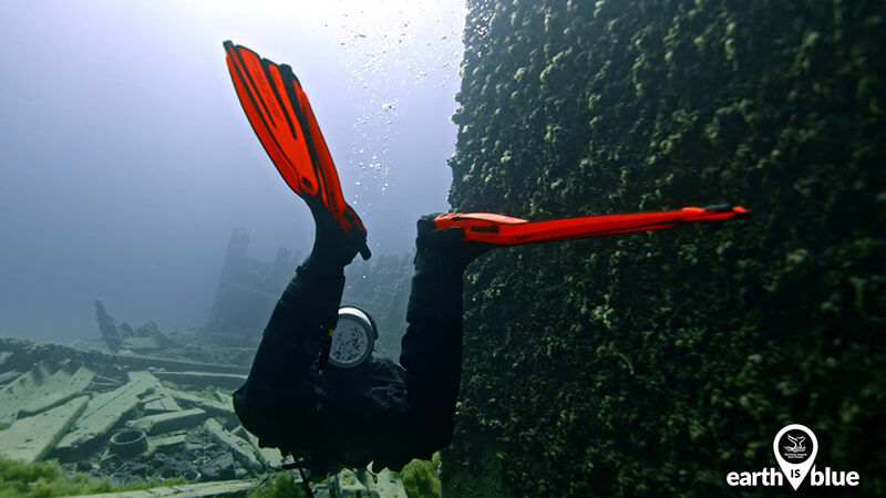 Diver inspects a shipwreck