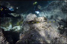 Divers document a cannon at the whaling shipwreck Gledstanes at Kure Atoll