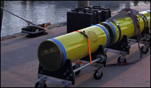 Autonomous Underwater Vehicle (AUV) sits on the dock before being loaded onto the RV-8501.
