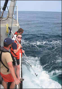 Sally Pryor follows Captain Bob's orders as she retrieves a buoy from the stern of the RV-8501.