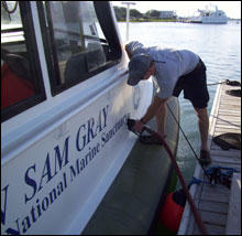Chad Meckley (NOAA Corp) tops off the gas tank of the R/V Sam Gray