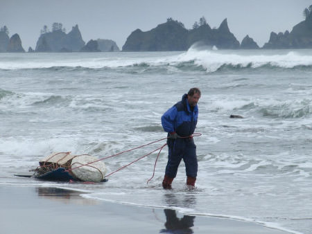 Volunteer removing debris from the beach