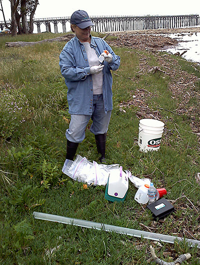 volunteer collecting water samples