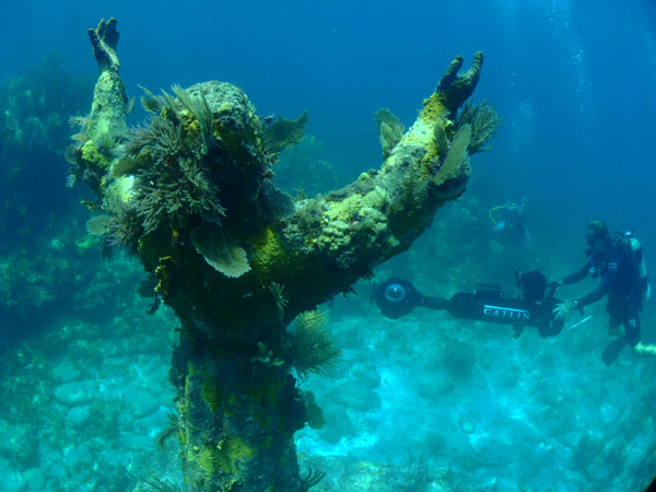 photo of a diver capturing a christ statue in the keys