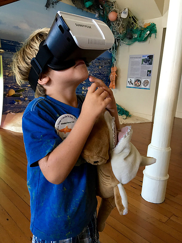 kid exploring the sanctuary virtually wearing a vr headset