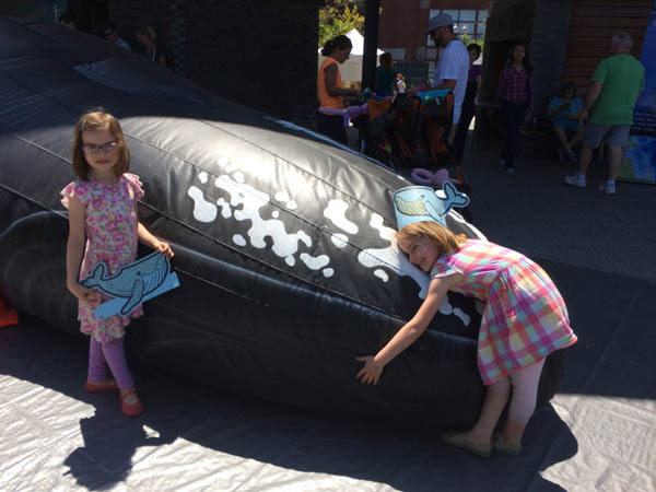 kids playing with salt, the inflatable life-sized humpback whale