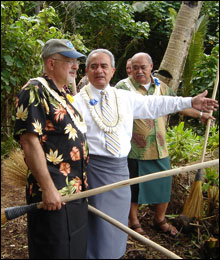 Daniel J. Basta, program director and Togiola T.A. Tulafono, Governor of American Samoa, take a moment to admire the new trail. They are holding traditional salutus used to sweep the trail's entrance.