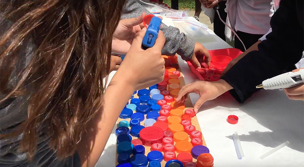 Middle School students created a mural using repurposed plastic bottle caps