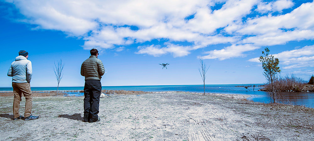 uas pilot controlling a uas in the background