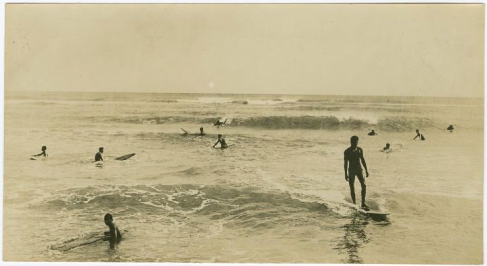 men surfing at Waikīkī, c. 1862