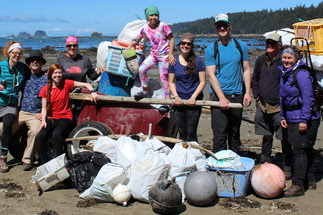 volunteers pose with the marine debris they collected from the beach