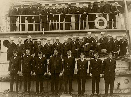 photo of the Ship's Company beside and on USS Conestoga