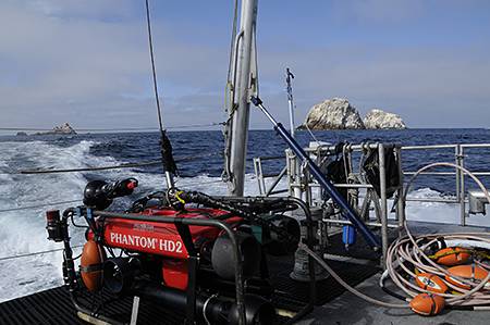view of rov on deck with farallon islands in the background