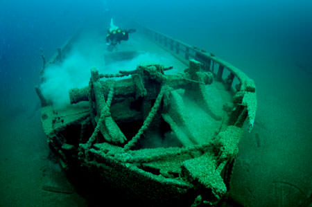 diver swimming over a shipwreck