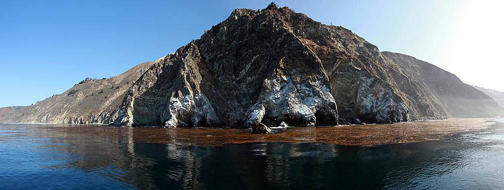 panorama view from the water of a rocky area of the big sur coastline