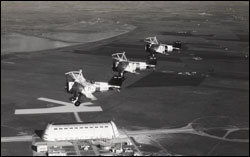 Figure 46b. Sparrowhawk bi-planes flying in formation over Moffett Field. The Curtiss aircraft company adapted their F9C-2 Sparrowhawk bi-plane fighters to be used aboard the