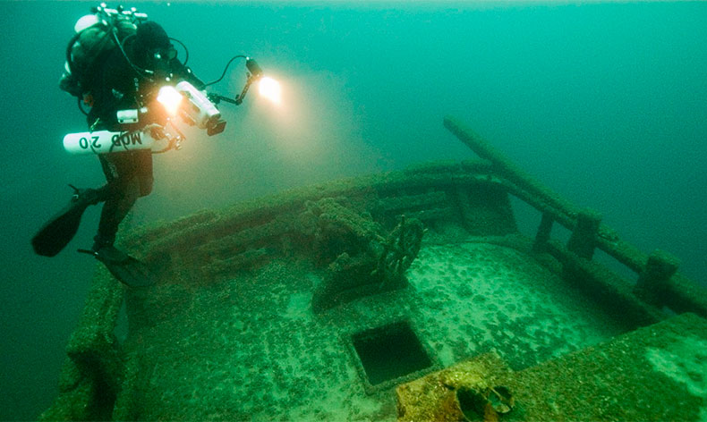 Photo of a diver and a shipwreck