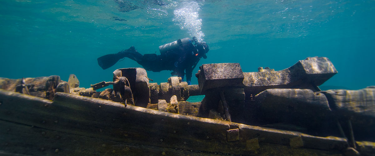 photo of diver and a shipwreck