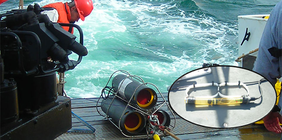photo of scientists deploying a recording package into the ocean