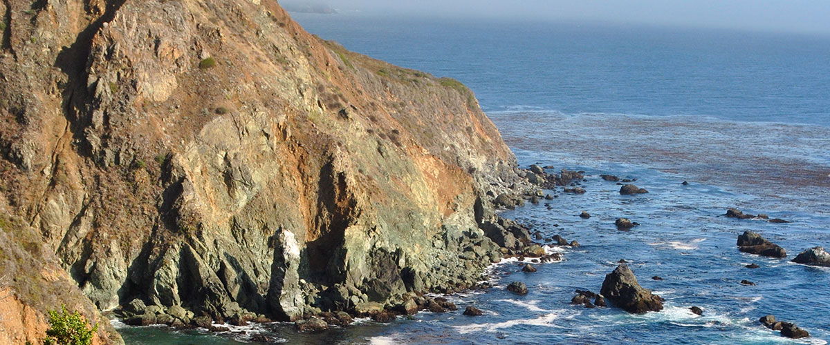 photo of rocks, cliffs and a beach in monterey bay