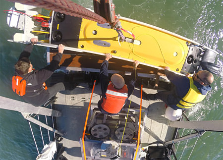 crew lowering Hibbard Inshore LLC Saab Sabertooth ROV / AUV into the water