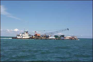 Contractor moves the construction barge to the Molasses Reef.