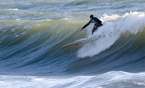 person surfing a wave in monterey bay