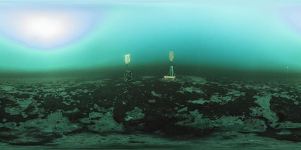 two sampling instruments situated atop large purple bacterial mats